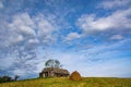 Haystack, mountain wooden hut and lonely tree on top of the hill under the picturesque sky, Borsa, Maramures, Romania Royalty Free Stock Photo