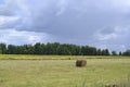 Haystack on a mown field under thunderclouds Royalty Free Stock Photo