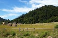 A haystack near the village at the foot of a mountain