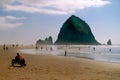 Haystack Rock with Beach Bike and Beachcombers Royalty Free Stock Photo