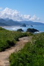 Haystack rock from Ecola State Park with path in foreground Royalty Free Stock Photo