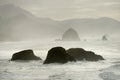Haystack rock and mountains in fog Royalty Free Stock Photo