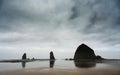 Haystack Rock Reflects In The Low Tide Of Canon Beach On Cloudy Morning Royalty Free Stock Photo