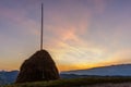 Haystack at Sunset with the Mountains behind It Royalty Free Stock Photo