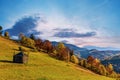 Haystack under wooden roof built behind fence in highland Royalty Free Stock Photo