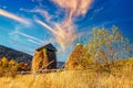 Haystack under wooden roof built behind fence in highland Royalty Free Stock Photo