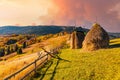 Haystack under wooden roof built behind fence in highland Royalty Free Stock Photo