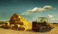 Haystacks on the field. old tractor and hay stack Royalty Free Stock Photo