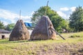 Haystacks in a small village. Mountain from view with small village sunny day.Sunny summer morning in the mountains and a small Royalty Free Stock Photo