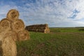 Haystacks in a village field, bales of hay lie on top of each other Royalty Free Stock Photo