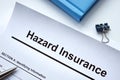 Hazard insurance policy form and pen.