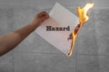 Hazard text on burning paper