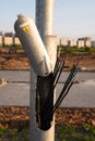 Hazardous area, metal pole, electrical wires are torn off, a danger sign on a pillar, construction of a house Royalty Free Stock Photo