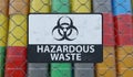 Hazardous waste sign on chain link fence. Oil barrels in background. 3D rendered illustration