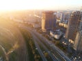 Haze lying over metropolis city with big railroad junction and roads. Smoke and mist covering buildings at skyline. Evening Royalty Free Stock Photo