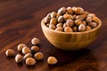 Hazelnut in brown wooden bowl on table Royalty Free Stock Photo