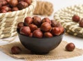 hazelnut covered served in a bowl isolated on napkin side view of nuts on grey background Royalty Free Stock Photo