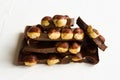 Hazelnut dark chocolate pieces tower on white background