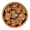 Hazelnut milk chocolate, bars broken into pieces, in a wooden bowl Royalty Free Stock Photo