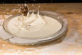Hazelnut in milk splash. Drops on a wooden table