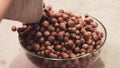 Hazelnut poured out of the sack into glass bowl