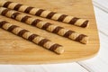 Hazelnut rolled wafer biscuit on grey wood