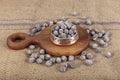 Hazelnut varieties in copper bowl on linen background. Roasted shelled hazelnuts, shelled hazelnuts and shellless roasted