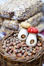 Hazelnuts in basket with nutcrackers shaped like mushrooms Royalty Free Stock Photo