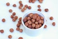 Hazelnuts in the bowl on the white background