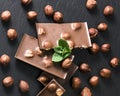 Hazelnuts, chocolate on a black board