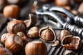 Hazelnuts with a classic silver nutcracker on wooden table Royalty Free Stock Photo