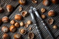 Hazelnuts with a classic silver nutcracker on wooden table Royalty Free Stock Photo