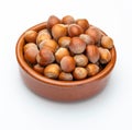 Hazelnuts in clay bowl Various nuts collection. Royalty Free Stock Photo