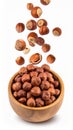 Hazelnuts Falling Into a Rustic Wooden Bowl on White Background for Healthy Food Royalty Free Stock Photo