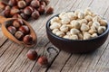 Hazelnuts, filbert in burlap sack and in bowl near wooden shovel on brown vintage table. heap or stack of hazelnuts. Hazelnut back Royalty Free Stock Photo