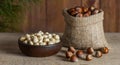 Hazelnuts, filbert in burlap sack and in brown bowl on rustic wooden table. heap or stack of hazelnuts. Hazelnut background, healt Royalty Free Stock Photo