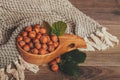 Hazelnuts with green leaves in wooden bowl Royalty Free Stock Photo