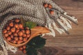 Hazelnuts with green leaves in wooden bowl, top view Royalty Free Stock Photo