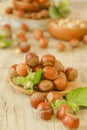 Hazelnuts harvest.Vegetable protein and healthy fat source. Whole and shelled organic hazelnuts on a wooden table