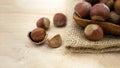 Hazelnuts beside the jute sack on wooden table Royalty Free Stock Photo