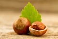 hazelnuts with leaves on old wooden background. Royalty Free Stock Photo