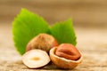 Hazelnuts with leaves on old wooden background. Royalty Free Stock Photo