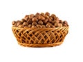 Hazelnuts with leaves in a wooden basket isolated on white background Royalty Free Stock Photo
