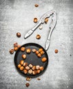 Hazelnuts and a Nutcracker in the old pan. Royalty Free Stock Photo