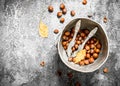 The hazelnuts in an old bucket with a Nutcracker. Royalty Free Stock Photo