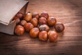 Hazelnuts paperbag on vintage wooden board food