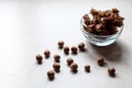 Hazelnuts scattered on the kitchen table, a Cup of nuts, side view-the concept of eating protein products