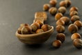 Hazelnuts in spoon on black background Royalty Free Stock Photo