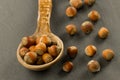 Hazelnuts in spoon on black background Royalty Free Stock Photo