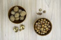 Hazelnuts and walnuts in a bowl with a few cracked next to it on the table. Flat lay. Royalty Free Stock Photo